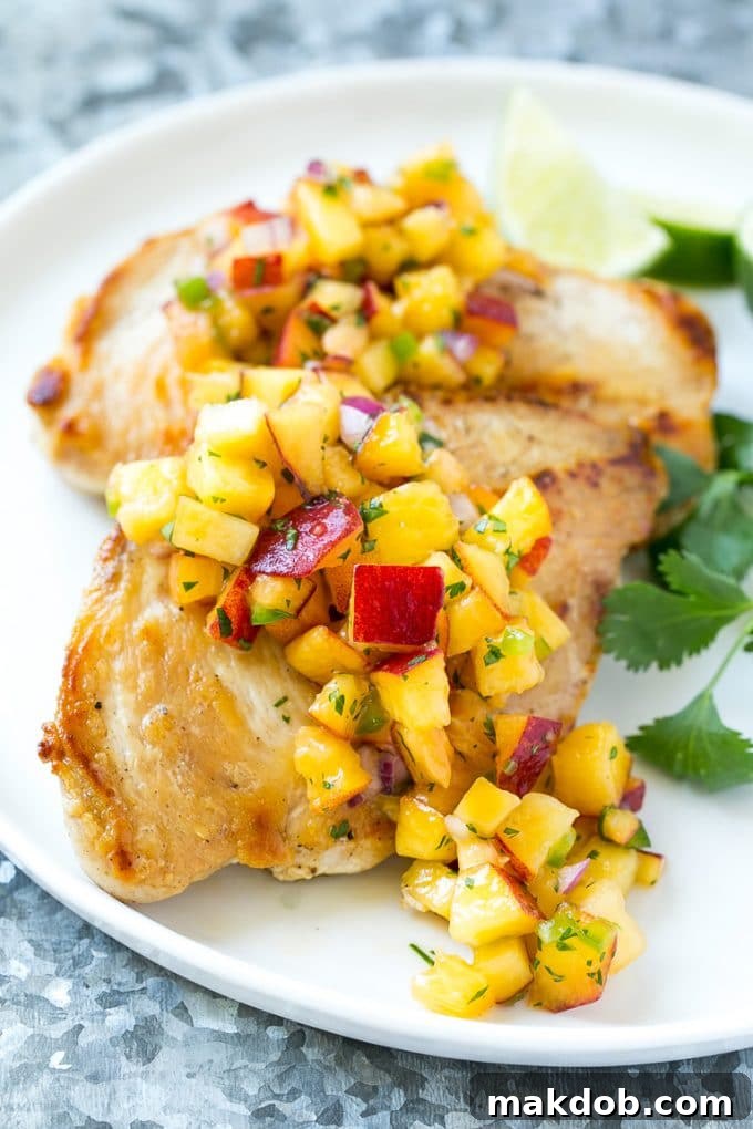 Peach salsa served over grilled chicken breast.