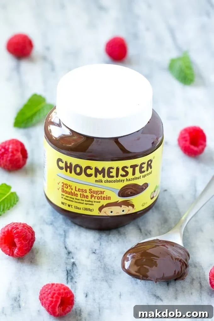 A jar of premium chocolate hazelnut spread, highlighting its smooth texture and rich color. Ideal for baking or a simple snack.