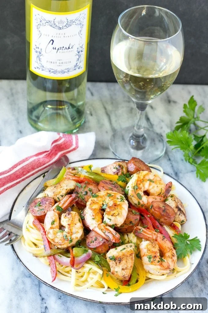 A plate of creamy Cajun jambalaya pasta garnished with fresh parsley, served alongside a glass of crisp white wine.