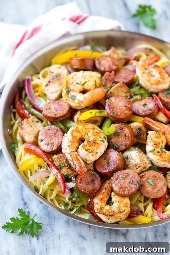 Creamy cajun pasta dish generously loaded with perfectly cooked shrimp, savory sausage, tender chicken, and colorful bell peppers.