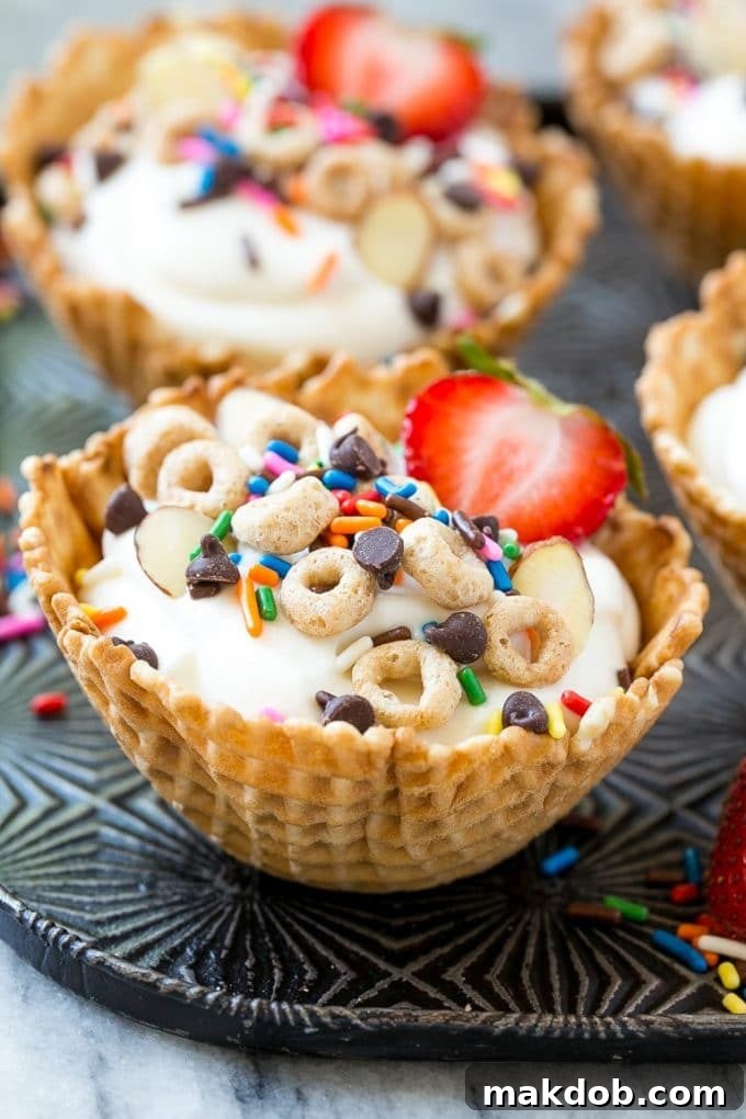 A close-up of a breakfast sundae highlighting the waffle cone cup filled with creamy yogurt, colorful sprinkles, and mini chocolate chips, an ideal sweet treat for breakfast.