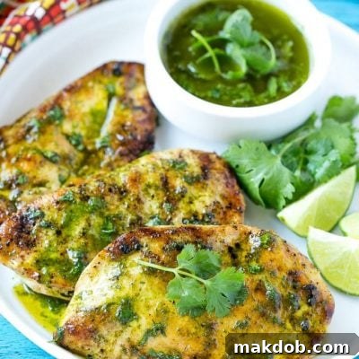 Cilantro Lime Chicken, marinated and grilled, served with a zesty sauce and lime wedges.