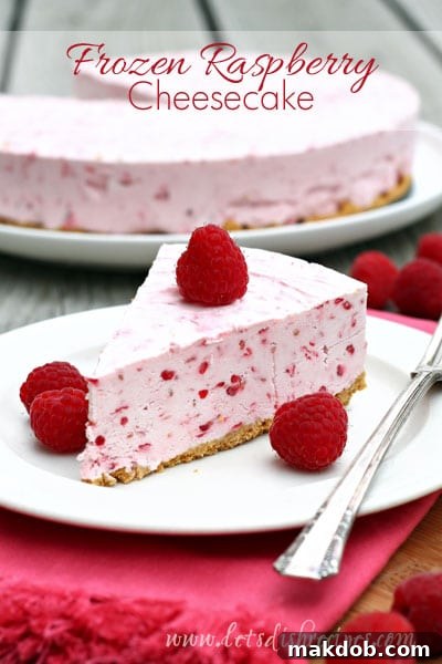 A cool and creamy Frozen Raspberry Cheesecake, featuring a vibrant raspberry swirl, ideal for a refreshing dessert.