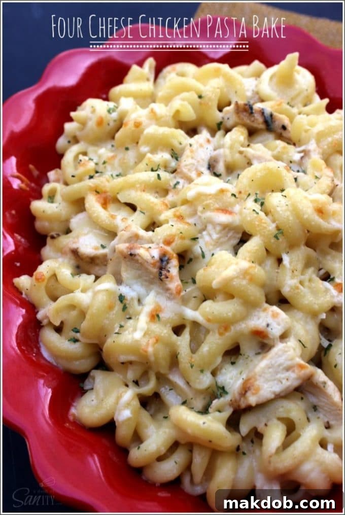 A rich and creamy Four Cheese Chicken Pasta Bake, featuring tender chicken and a blend of four delicious cheeses, perfect for a comforting Monday dinner.