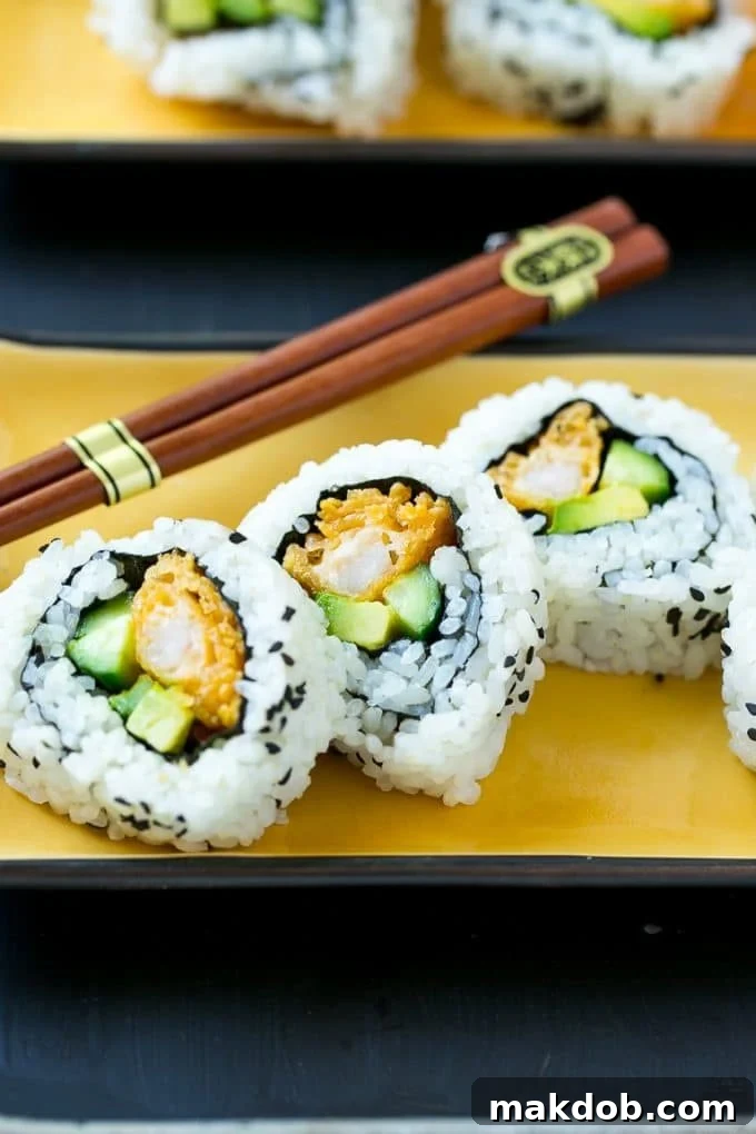 Shrimp Tempura Sushi Roll | Shrimp Tempura Sushi | Shrimp Sushi #sushi #tempura #shrimp #dinner #dinneratthezoo Sliced shrimp tempura roll sushi on a serving plate.