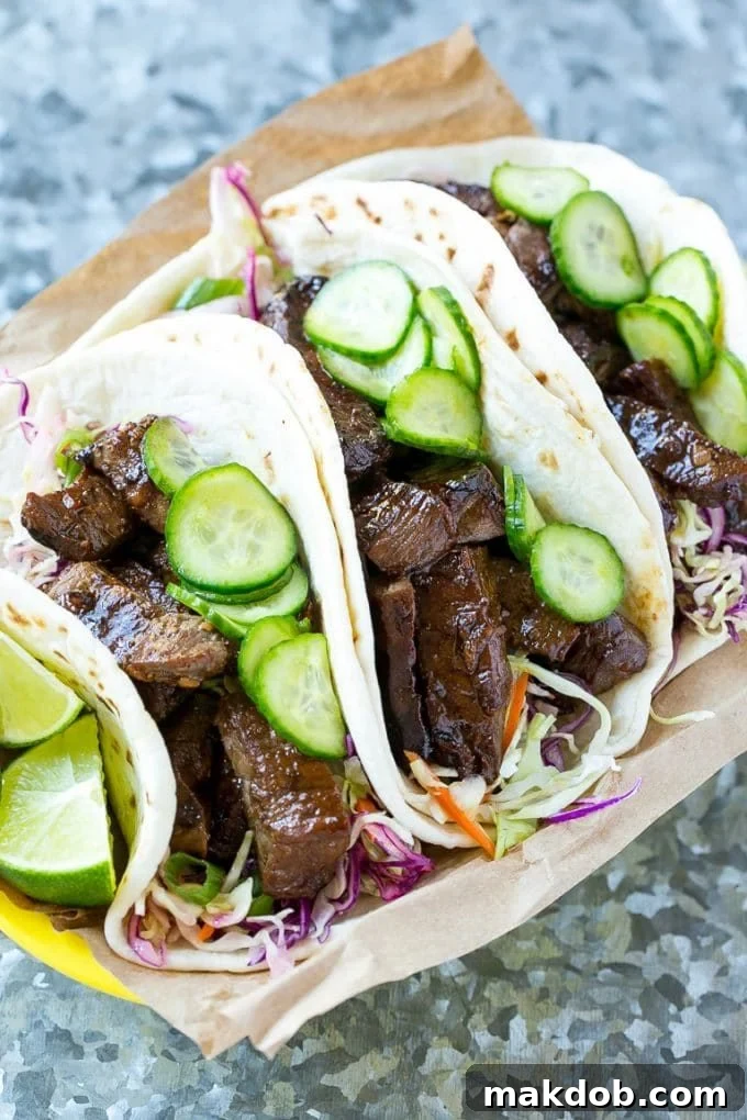 Asian style steak tacos filled with tender marinated beef, crispy cabbage, and refreshing pickled vegetables, all tucked into warm flour tortillas.
