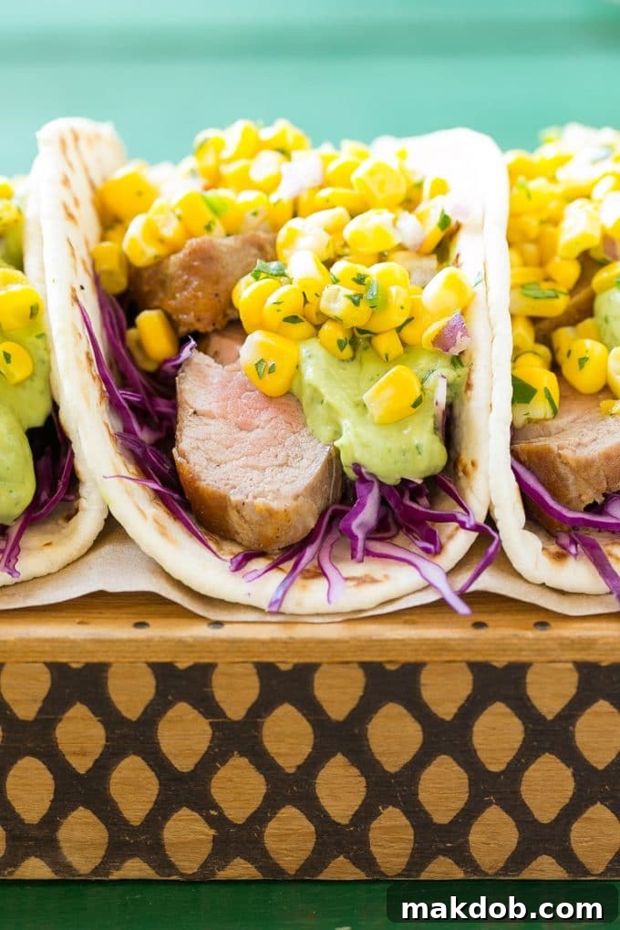 This recipe for pork tenderloin tacos is thinly sliced seasoned pork, layered with cabbage, corn salsa and creamy avocado sauce, all tucked inside warm flour tortillas. A unique take on taco night!