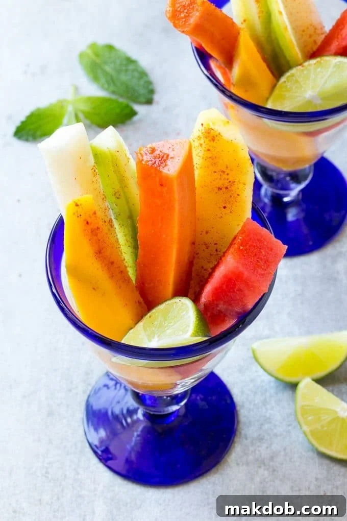 Mexican Fruit Cups | Fruit Cups | Mexican Fruit | Tropical Fruit #fruit #fruitcup #watermelon #pineapple #snack #healthy #dinneratthezoo Spears of colorful fresh fruit, cucumbers and jicama in Mexican fruit cups.