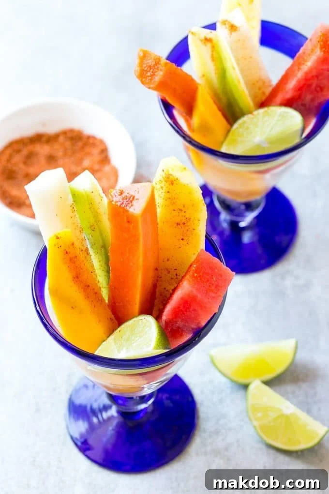 Mexican Fruit Cups | Fruit Cups | Mexican Fruit | Tropical Fruit #fruit #fruitcup #watermelon #pineapple #snack #healthy #dinneratthezoo Spears of watermelon, cucumber, jicama, mango and pineapple in glasses.