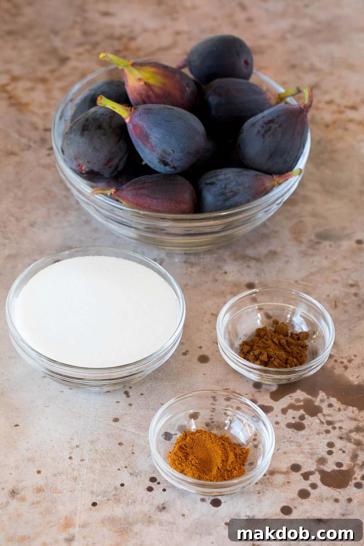 Luscious Roasted Figs 3 Bowls filled with fresh figs, granulated sugar, ground cinnamon, and ground cloves, ready for roasting.