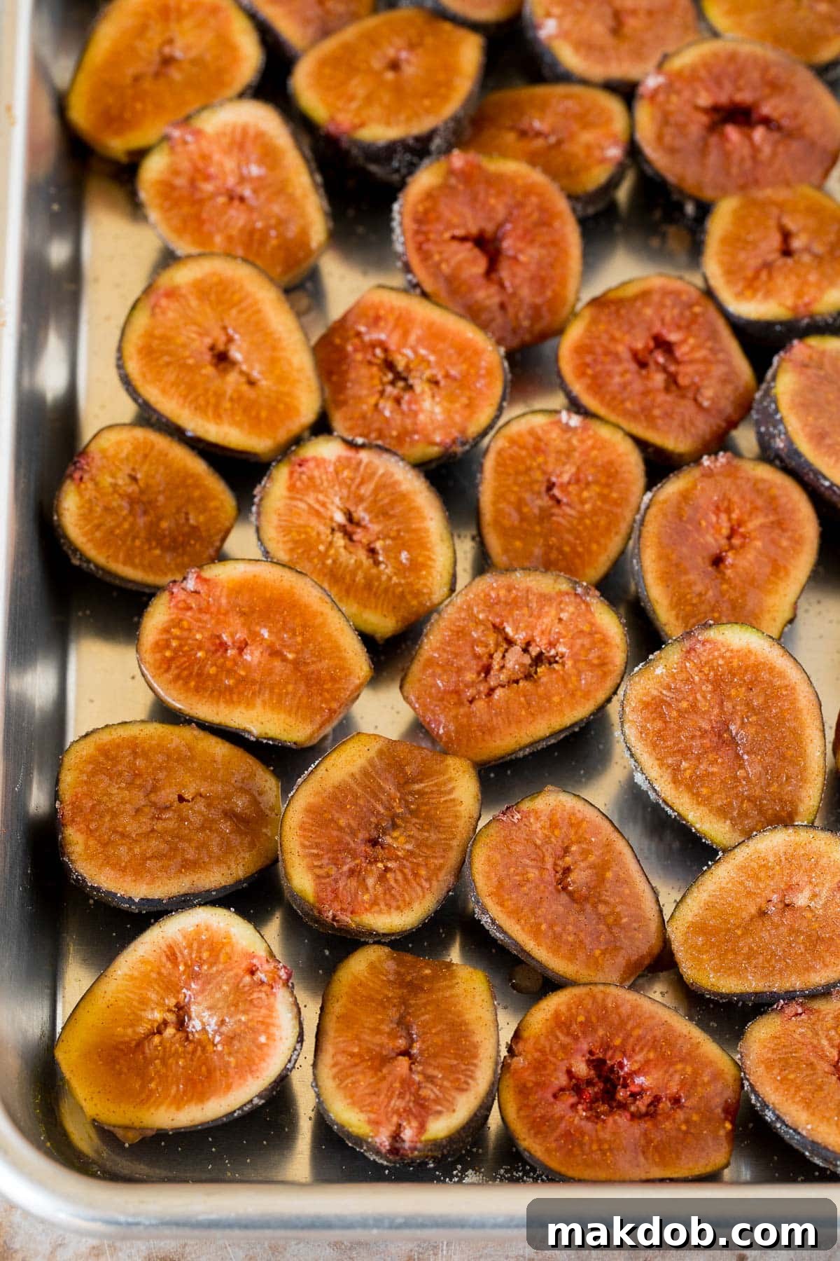 Luscious Roasted Figs 6 Fig halves arranged neatly on a sheet pan, ready to be broiled to caramelized perfection.