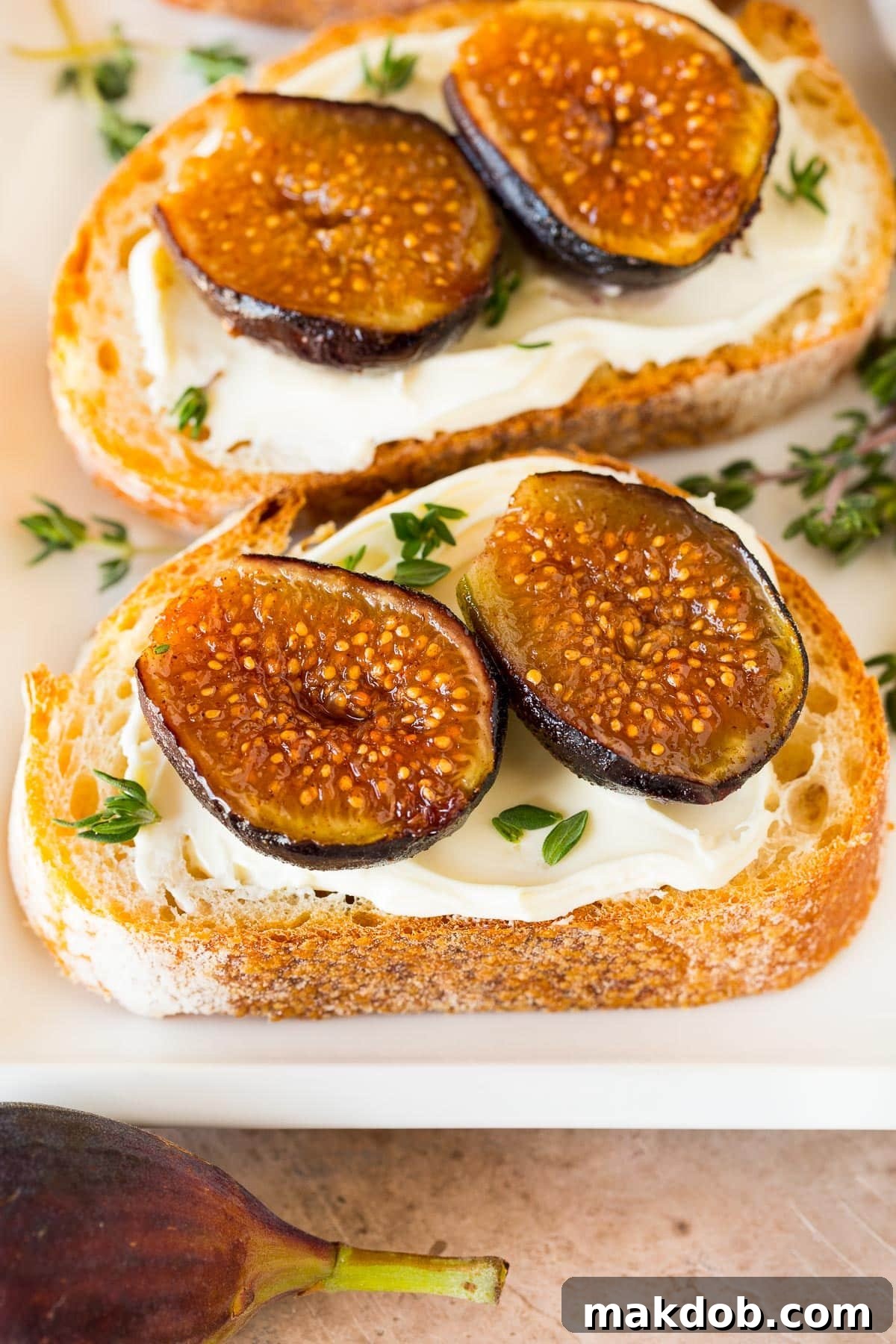 Luscious Roasted Figs 7 Roasted figs served on crostini with creamy cheese and a garnish, illustrating a gourmet appetizer idea.
