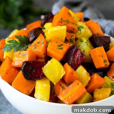 A bowl of diced roasted root vegetables topped with parsley.