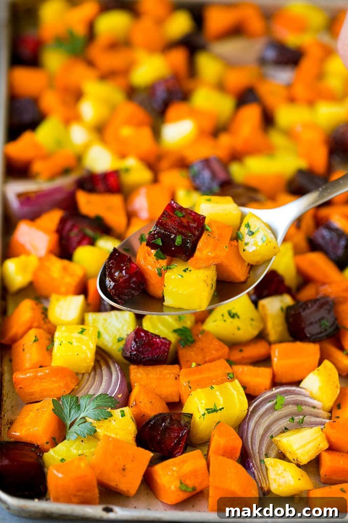A spoon serving up a portion of roasted vegetables.