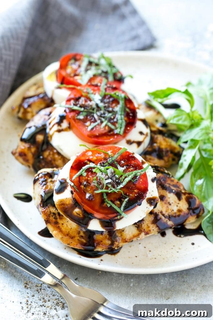 Grilled chicken breasts topped with melted mozzarella cheese, fresh tomatoes and basil.