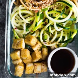 A bowl of spicy tofu zucchini noodles, perfect for meal prep.