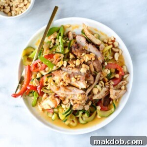 A bowl of Thai-style drunken zucchini noodles paired with spicy honey chicken.