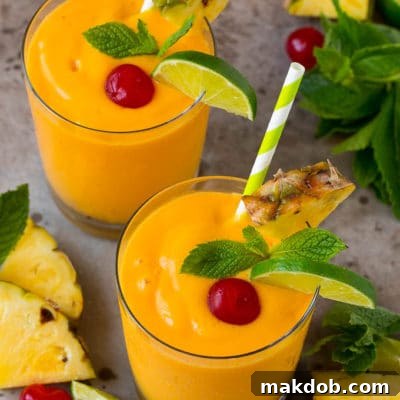 Island Escape Smoothie 3 Tropical smoothies garnished with mint, limes and pineapple.