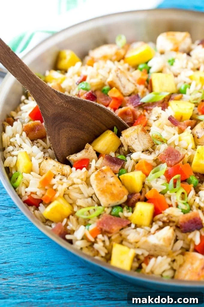 Delicious pineapple fried rice loaded with chicken, bacon, crunchy veggies and juicy pineapple, perfect as a main course or side dish, much better than take out.