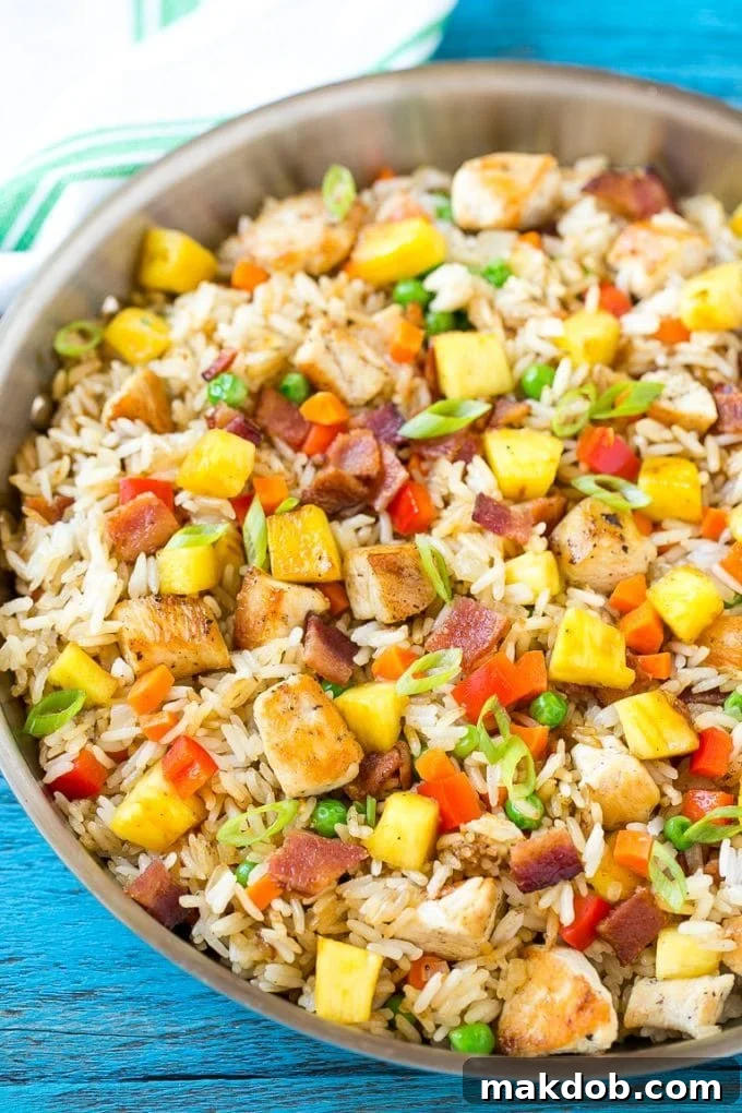 Ingredients prepared for pineapple fried rice, showing diced chicken, vegetables, and rice ready for cooking, ensuring a simple and easy meal.