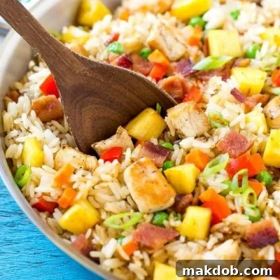This recipe for pineapple fried rice is loaded with chicken, bacon, crunchy veggies and juicy pineapple. A simple and easy main course or side dish that's MUCH better than take out! #Back2SchoolSuccess #ad