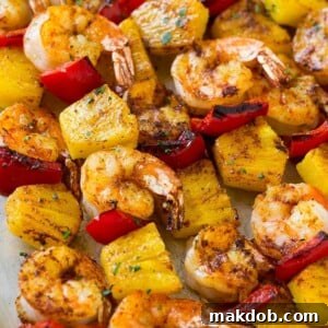 Flavorful skewers of jerk shrimp and sweet pineapple, beautifully topped with fresh parsley.