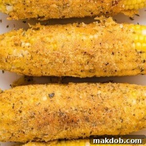 Several ears of deep-fried corn on the cob, boasting a golden-brown, crispy batter. The image highlights the crunchy exterior and promises a sweet, tender interior, offering a unique and indulgent take on preparing corn that's sure to be a crowd-pleaser with its satisfying texture and rich flavor.