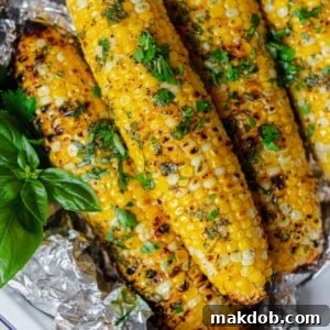 A vibrant image of lemon pepper corn on the cob, glistening with a savory herb and lemon pepper butter. The golden kernels are infused with bright citrus notes and a subtle peppery kick, presenting a refreshing and aromatic way to enjoy corn, especially suitable for plant-based diets.