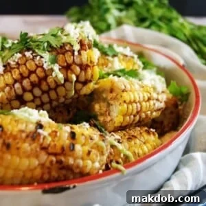 An enticing image of a bowl filled with spicy ancho grilled corn on the cob, garnished beautifully for a flavorful presentation.