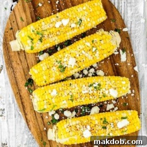 Four perfectly cooked ears of Instant Pot corn on the cob, arranged enticingly on a simple plate, promising quick and consistently tender results. The image conveys the efficiency of pressure cooking for achieving ideal corn texture, making it an excellent choice for fast and delicious meals.