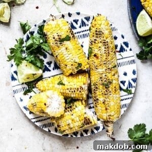 A tantalizing image showcasing perfectly grilled cilantro lime corn on the cob, highlighting its vibrant green herbs and inviting char marks.