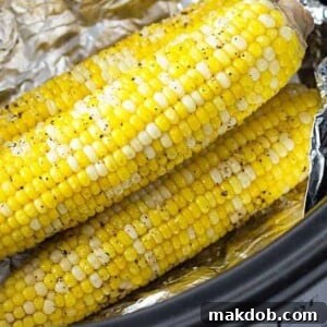 A slow cooker filled to the brim with multiple ears of corn on the cob, perfectly stacked and ready for cooking. The image conveys the convenience and hands-off approach of using a Crockpot to prepare tender, flavorful corn, ideal for large gatherings or busy schedules.