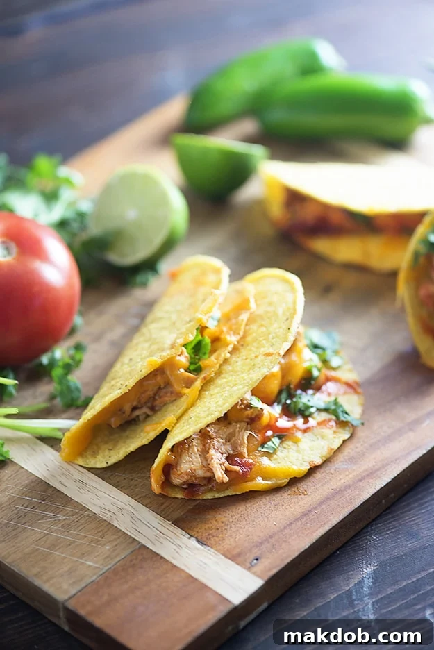 Slow Cooker Chicken Tacos, an effortless and customizable family dinner with shredded chicken and various toppings.