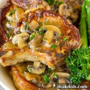 Perfectly cooked Instant Pot pork chops, generously topped with a rich and savory mushroom gravy.