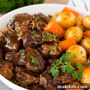 Hearty Instant Pot pot roast with tender carrots and potatoes, garnished with fresh parsley for a touch of color.