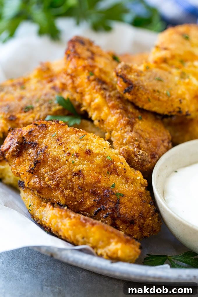 Baked Fried Chicken Recipe | Oven Fried Chicken | Baked Chicken Fingers | Crispy Chicken Fingers Baked oven fried chicken fingers in a dish with a side of ranch dressing.