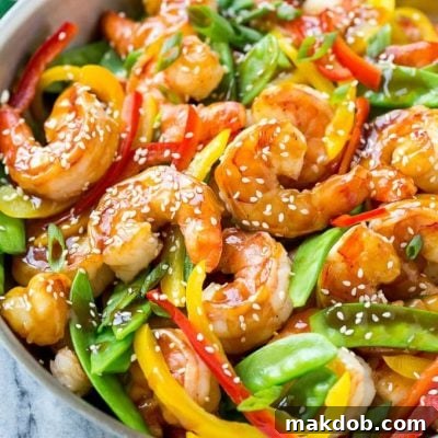 This recipe for teriyaki shrimp stir fry is shrimp and vegetables coated in a homemade teriyaki sauce and served over brown rice. An easy and healthy dinner option that's ready in less than 20 minutes! AD