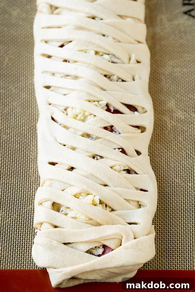 Pizza dough braided around Italian meats, cheese and tomato sauce.