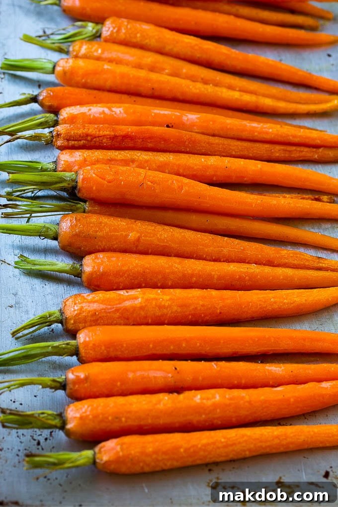 Roasted honey carrots on a sheet pan.