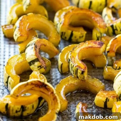 This delicata squash recipe is roasted with brown sugar, maple syrup and cinnamon for a sweet and savory side that's perfect for fall and winter meals.
