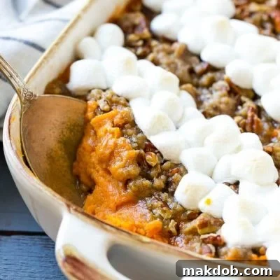 This recipe for a sweet potato casserole with marshmallows is mashed spiced sweet potatoes, topped with both a pecan streusel topping and plenty of mini marshmallows. A holiday classic that's a family favorite!