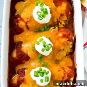 A delicious dish of baked salsa chicken, generously topped with melted cheese and a dollop of sour cream.