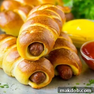 Bagel dogs, golden brown and perfectly baked, served with classic condiments like ketchup and mustard.