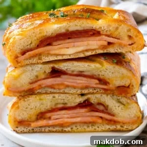 A savory stromboli recipe, featuring pepperoni, ham, and cheese deliciously wrapped in pizza dough and baked to golden perfection.