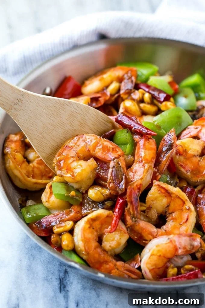 Kung Pao Shrimp | Shrimp Recipe | Shrimp Stir Fry | Easy Shrimp Recipe #shrimp #stirfry #peppers #dinner #dinneratthezoo #spicy A serving spatula in a pan of Kung Pao shrimp.
