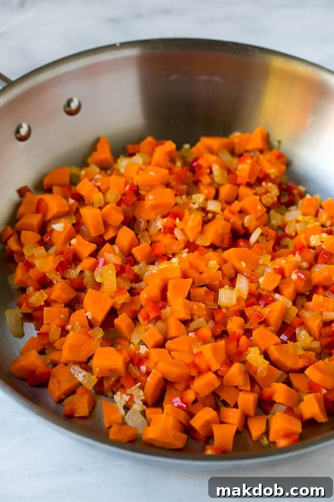 Veggie Fried Rice Recipe | Vegetarian Fried Rice #rice #friedrice #vegetarian #dinner #dinneratthezoo #sidedish Cooked vegetables in a skillet for veggie fried rice, vibrant and fresh.