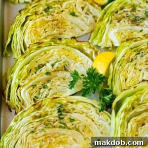 A pan of perfectly roasted cabbage wedges, beautifully caramelized and topped with a sprinkle of fresh green parsley, ready to be served.