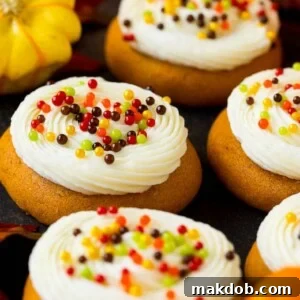 Soft and delicious pumpkin cookies, beautifully topped with a generous swirl of creamy cream cheese frosting and festive fall sprinkles.