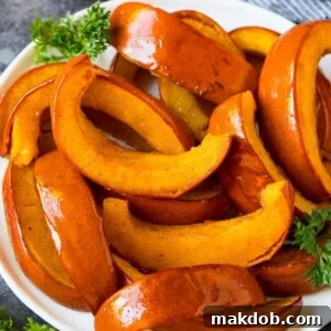 Perfectly roasted pumpkin slices, caramelized and tender, presented on a serving plate, highlighting their rich color and appealing texture.