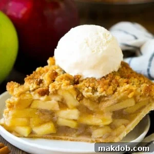 A beautifully baked Dutch apple pie, showcasing its tender and flaky crust filled with sweetened apples, topped with a golden brown sugar crumb.